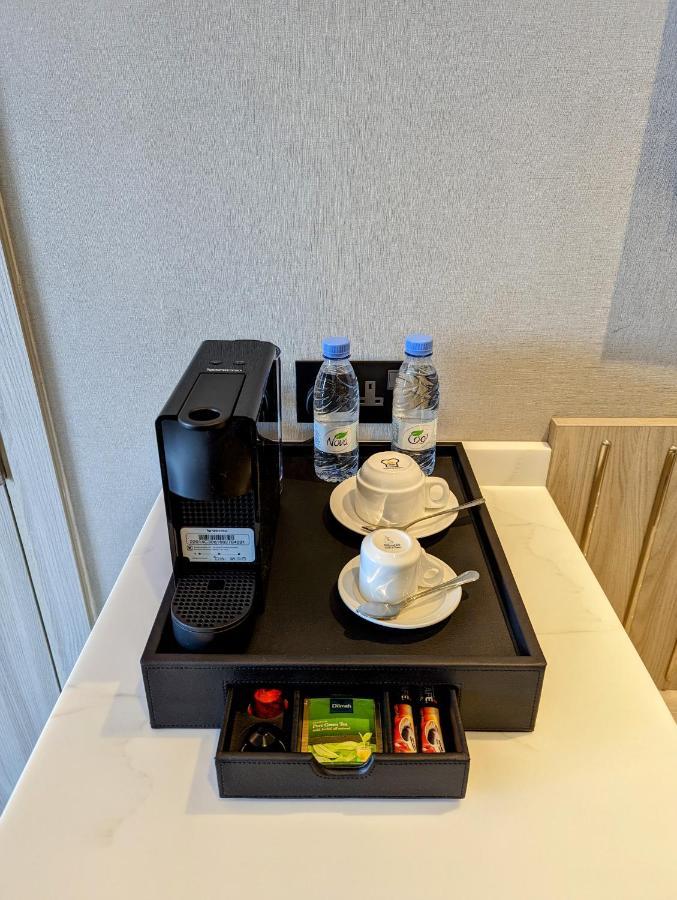 Citadines Abha Aparthotel Kültér fotó A Nespresso coffee machine in a hotel room